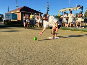 Group playing barefoot lawn bowls at Camden Sports Club