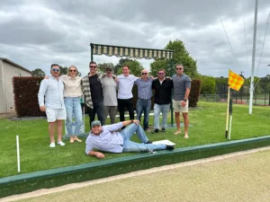 Barefoot bowls party group posing for a fun group photo.